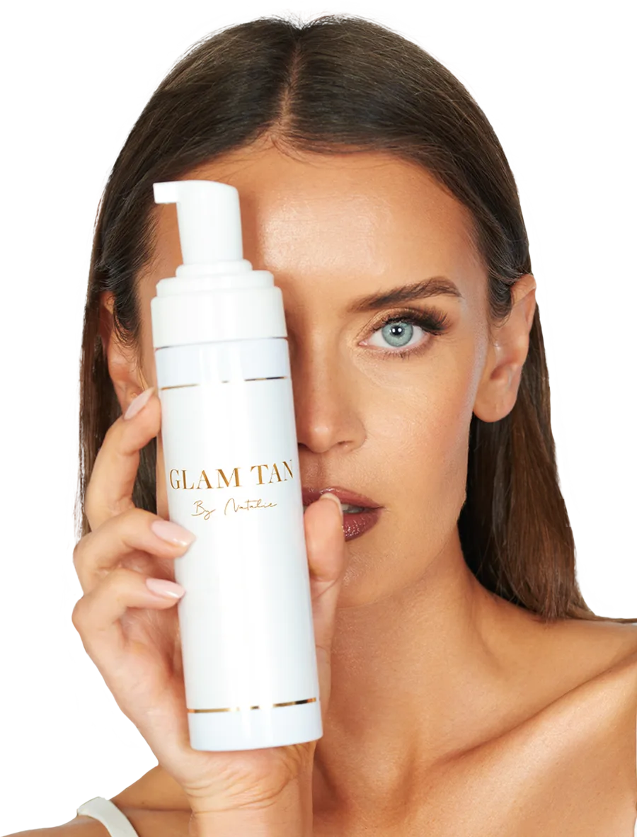 Model holding Glam Tan bronzing mousse
