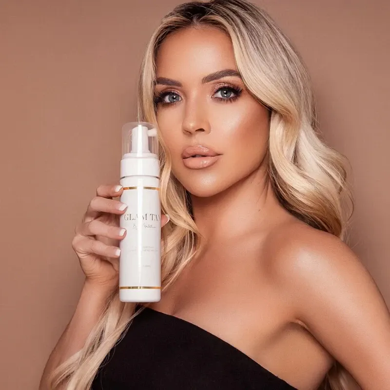 Natalie McAteer holding Glam Tan bronzing mousse